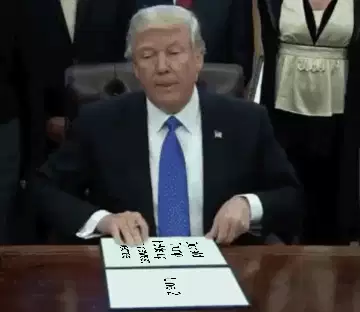Donald Trump holds up the newest decree meme
