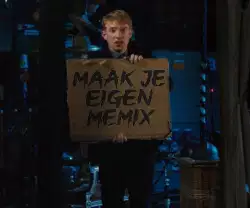 A Man Holds Cardboard Sign 