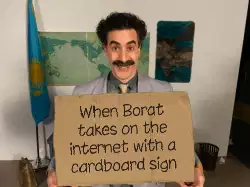 When Borat takes on the internet with a cardboard sign meme