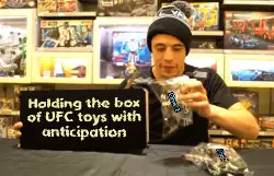Holding the box of UFC toys with anticipation meme