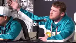 Canelo Alvarez steps up to the stage in his Team Canelo sweatpants and hoodie meme