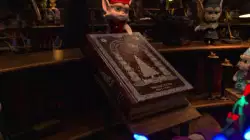 Elf Opens Up Book For Santa 