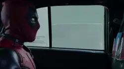 Deadpool Looks At Pamphlet In Taxi 