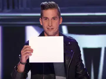 Man Shows Sign On Stage 