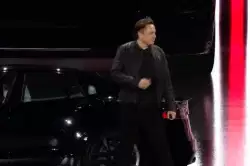 Elon Musk entering the room with a smile and a gesture of eager enjoyment meme