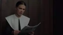 Millie Bobby Brown Looks At Papers 
