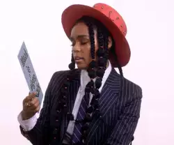 Janelle Monáe Holds Up Sign 