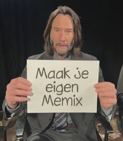 Keanu Reeves Holds Up Paper 