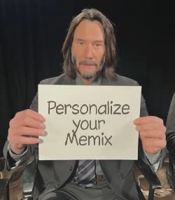 Keanu Reeves Holds Up Paper 