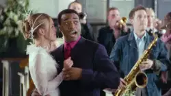 Man At Wedding Points At Something 