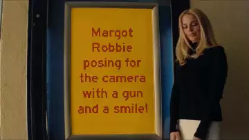 Margot Robbie posing for the camera with a gun and a smile! meme