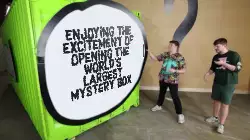 Enjoying the excitement of opening the world's largest mystery box meme