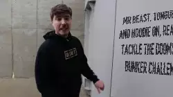 Mr Beast, tongue out and hoodie on, ready to tackle the doomsday bunker challenge meme