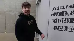 Mr Beast, tongue out and hoodie on, ready to take on the doomsday bunker challenge meme