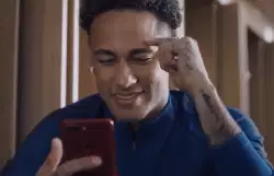 Trying to keep a smile while holding a mobile phone meme