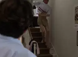Man Goes Down Stairs With White Shirt 