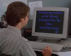 Staring down a broken computer in the workplace meme