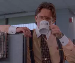 Man Sips Mug in Office 