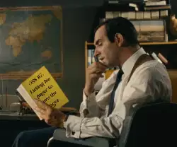 OSS 117: Licking his finger to turn the pages meme