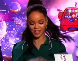 Rihanna Holds Up Little White Sign 