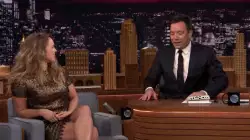 Ronda Rousey: Smiling, Sitting, and Showing Off Her Book on the Tonight Show meme