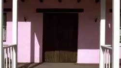 A Man Walks Through Entrance 