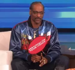 Snoop Dogg Holds Up Sign 