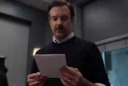 Ted Lasso Puts Paper On Desk 