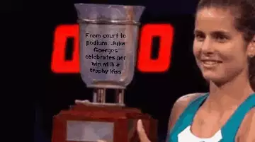 From court to podium: Julia Goerges celebrates her win with a trophy kiss meme