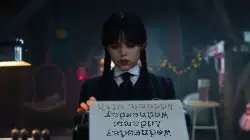 Wednesday Addams: Wednesday Addams, with her typewriter and her poker face meme