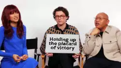 Holding up the placard of victory meme